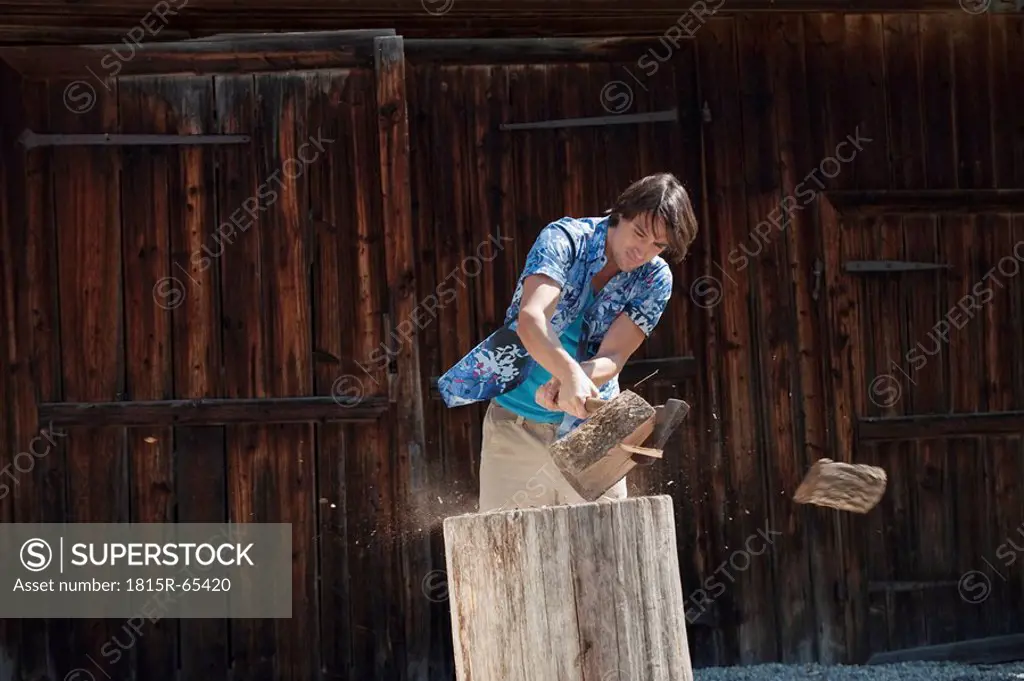 Germany, Bavaria, Man chopping wood