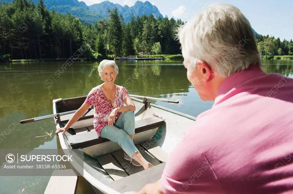 Italy, South Tyrol, Senior couple in rowing boat, portrait