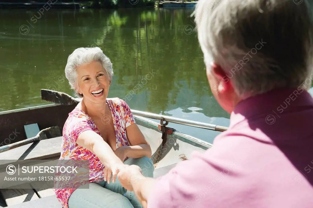 Italy, South Tyrol, Senior couple in rowing boat, portrait