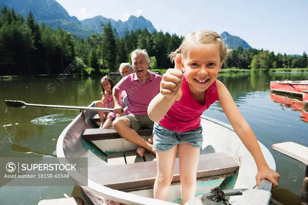 Italy, South Tyrol, Grandparents and children 6_7 8_9 in rowing boat on lake, portrait