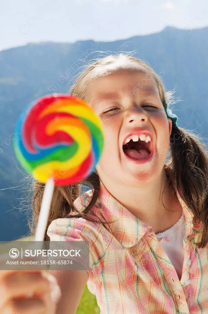 Italy, South Tyrol, Girl 6_7 holding lollypop