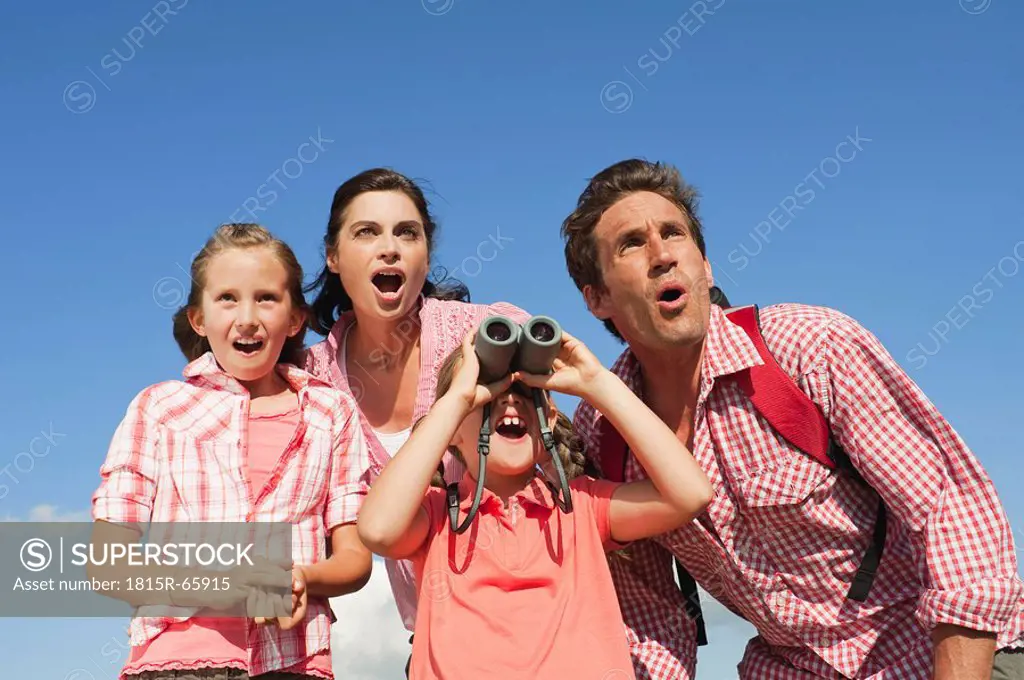 Italy, South Tyrol, Family with children 6_7 10_11, girl looking through binoculars, portrait