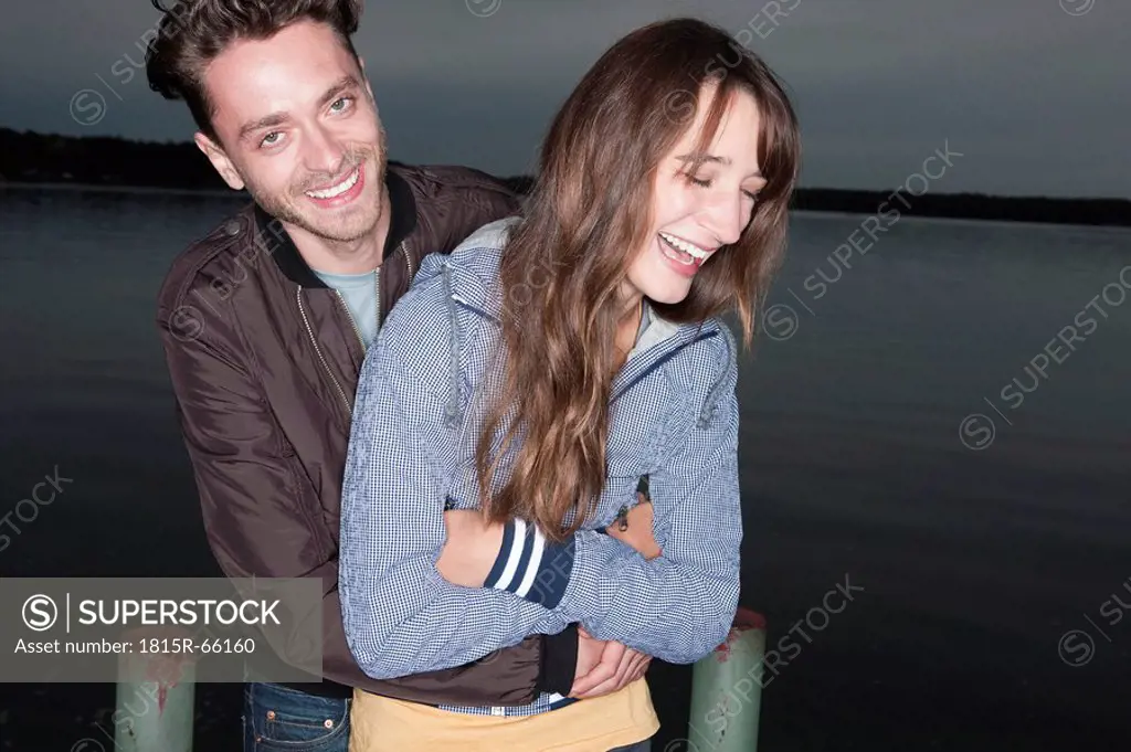 Germany, Berlin, Lake Wannsee, Young couple having fun, laughing