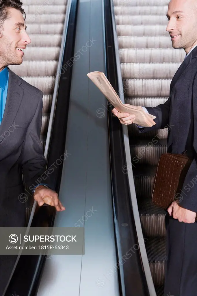 Germany, Bavaria, Munich, Two businessmen on escalator