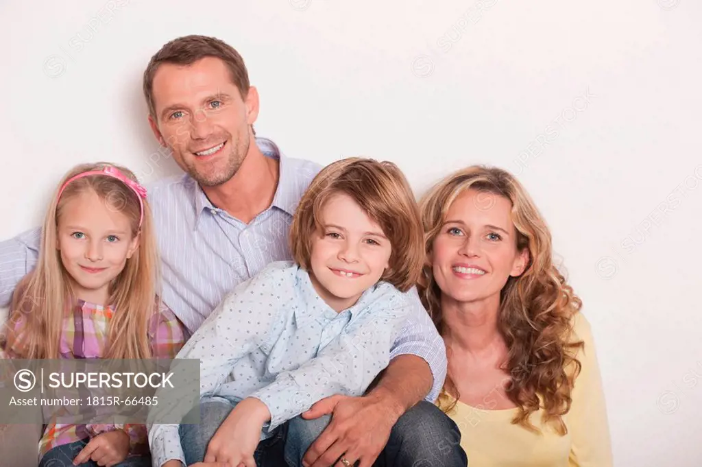 Germany, Cologne, Family sitting on steps of staircase, laughing, portrait, close_up