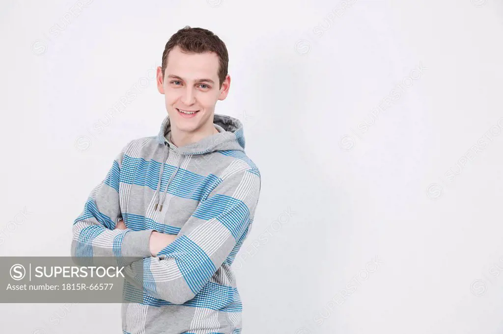 Man looking at camera, smiling, arms crossed