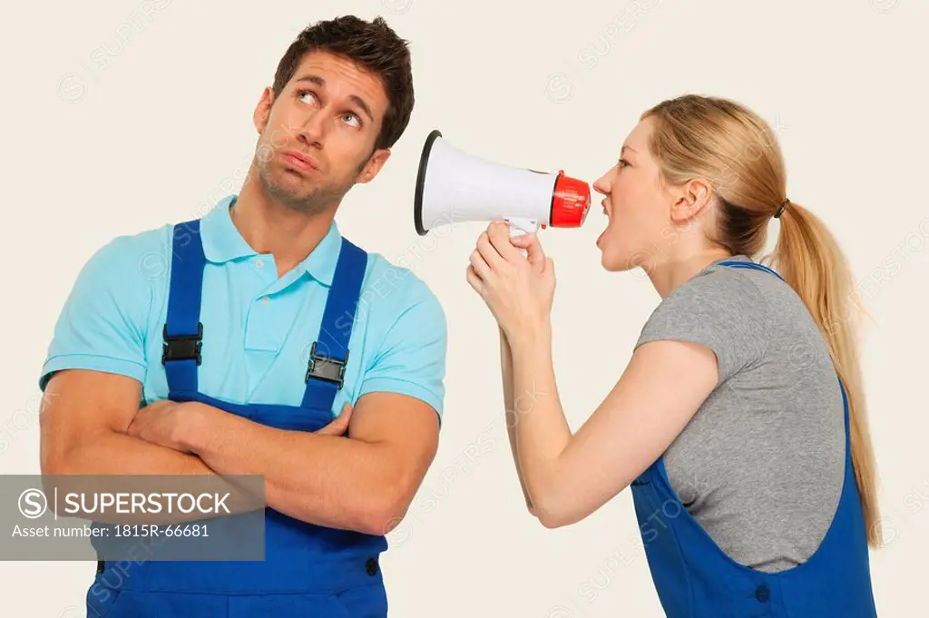 Woman shouting at man through megaphone, close_up