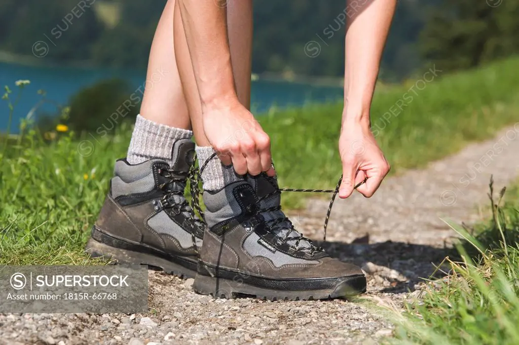 Austria, Lake Mondsee, Person tying shoe