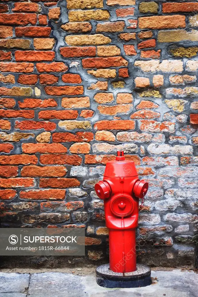 Water hydrant against brick wall