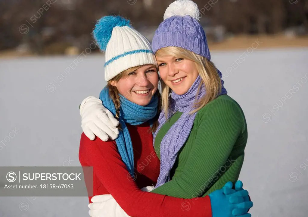Austria, Salzkammergut, Lake Irrsee, Female teenagers 14_15 embracing, portrait