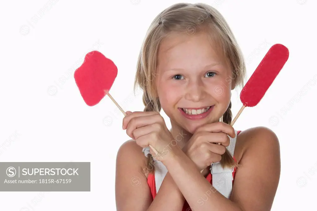 Girl 10_11 holding lollypops, smiling, portrait