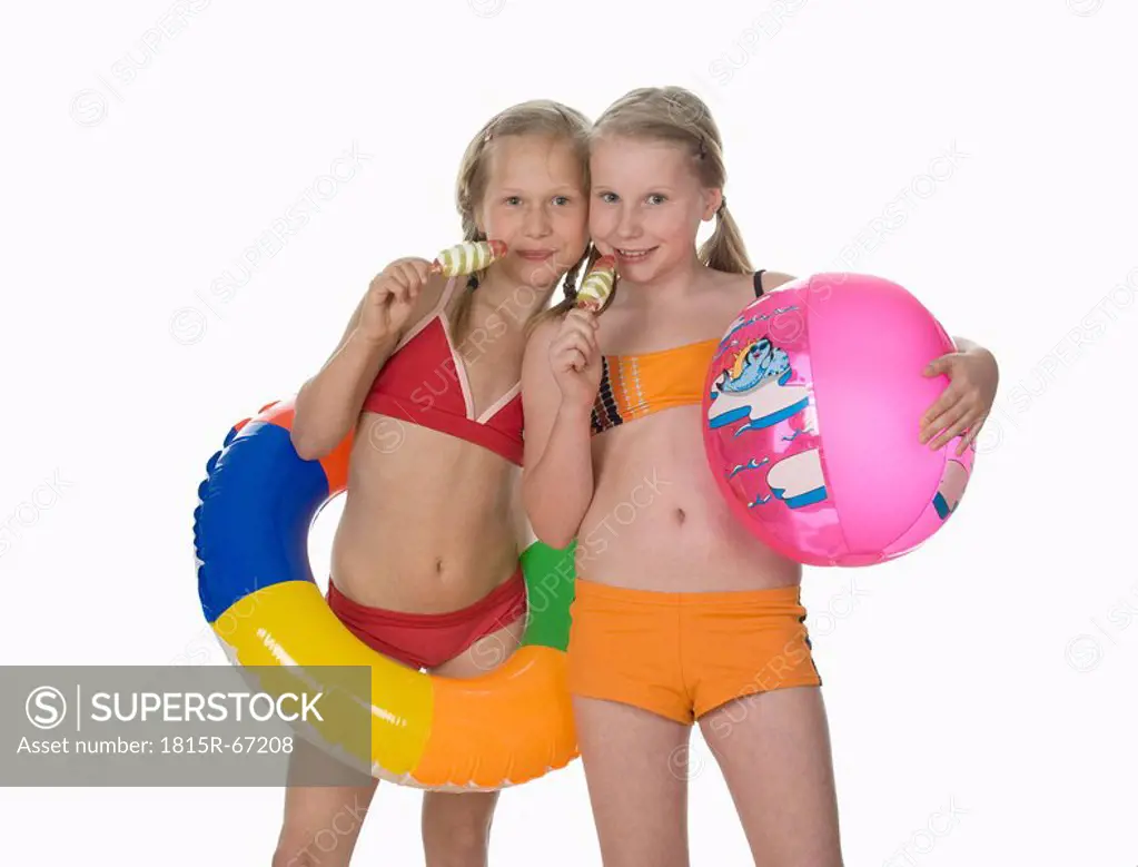 Two girls 10_11 wearing bikini, holding ice cream, portrait