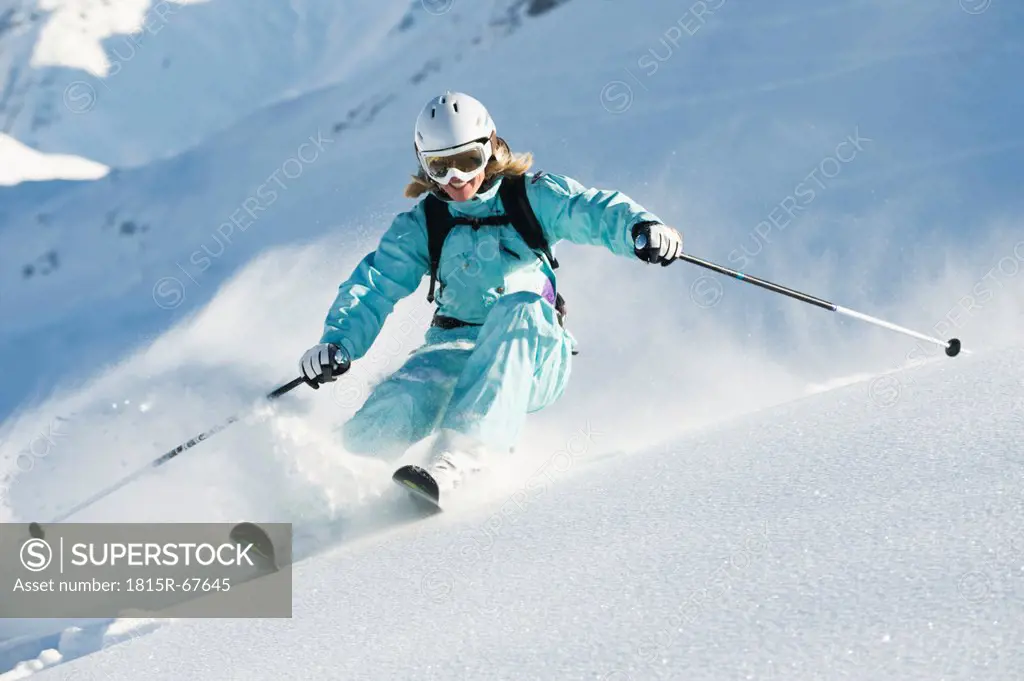 Austria, Woman skiing on arlberg mountain, smiling
