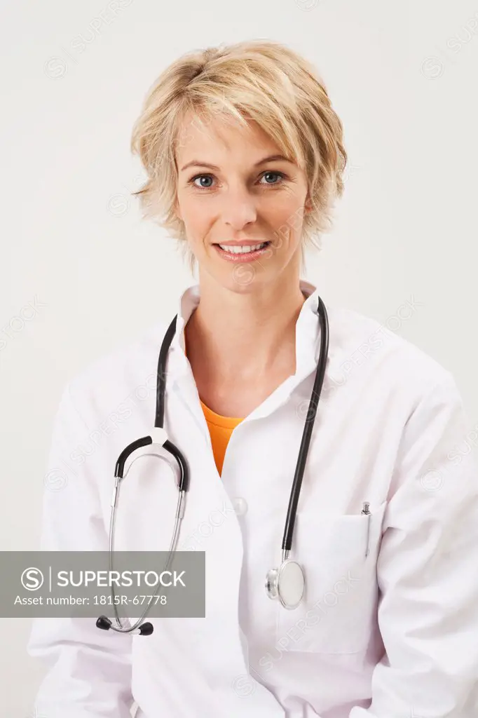 Germany, Munich, Female doctor with stethoscope, smiling, portrait