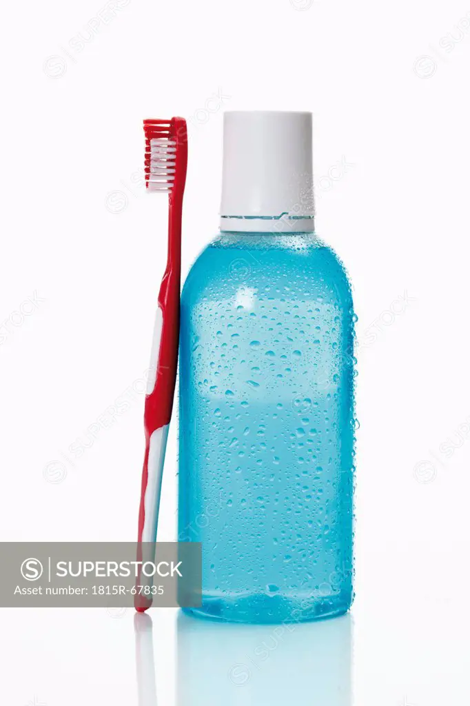 Toothbrush and mouthwash on white background