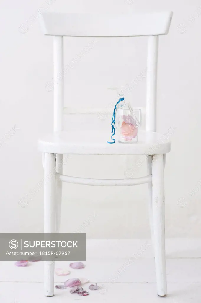 Sugared rose petals in glass on chair
