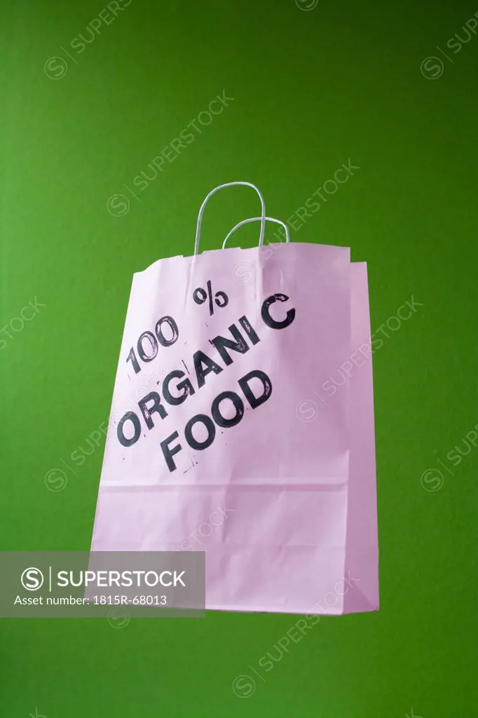 Paper bag on green background