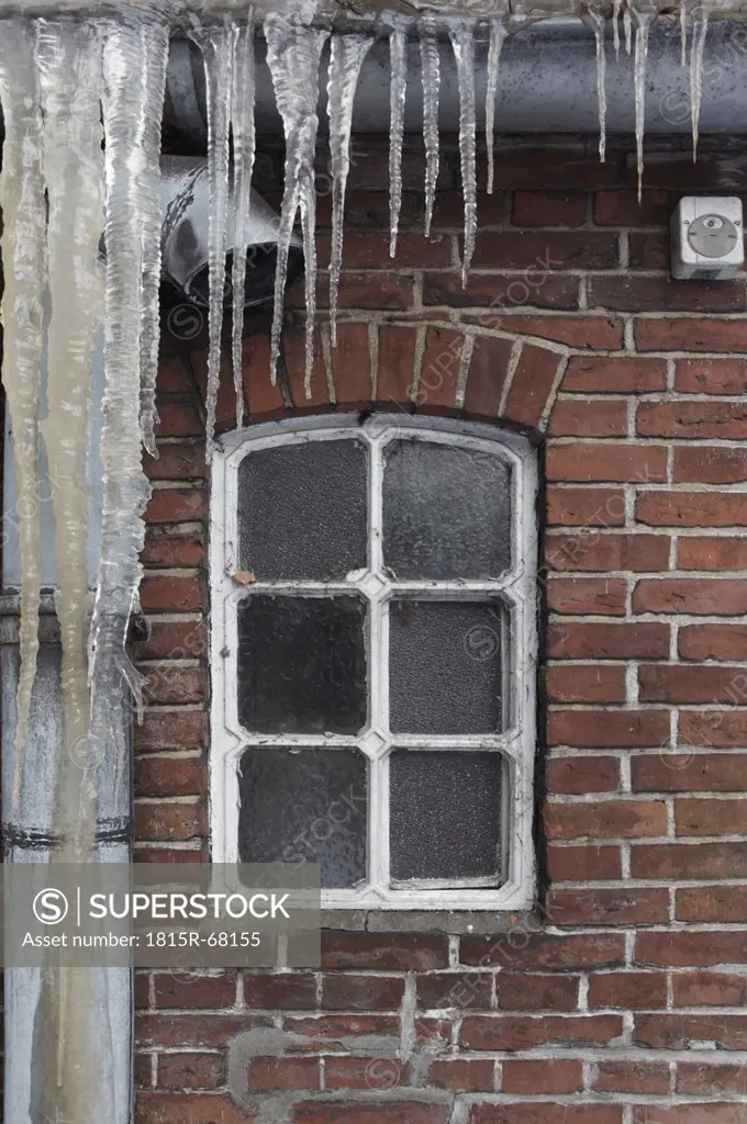 Germany, Hamburg, View of house window with icicles in foreground