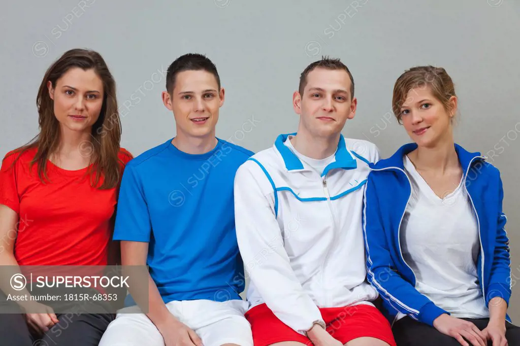 Germany, Berlin, Young men and women smiling, portrait