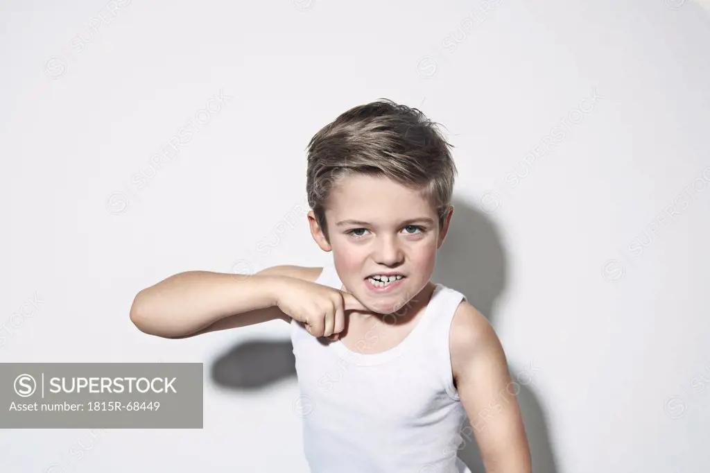 Boy 8_9 standing against white background, gesturing