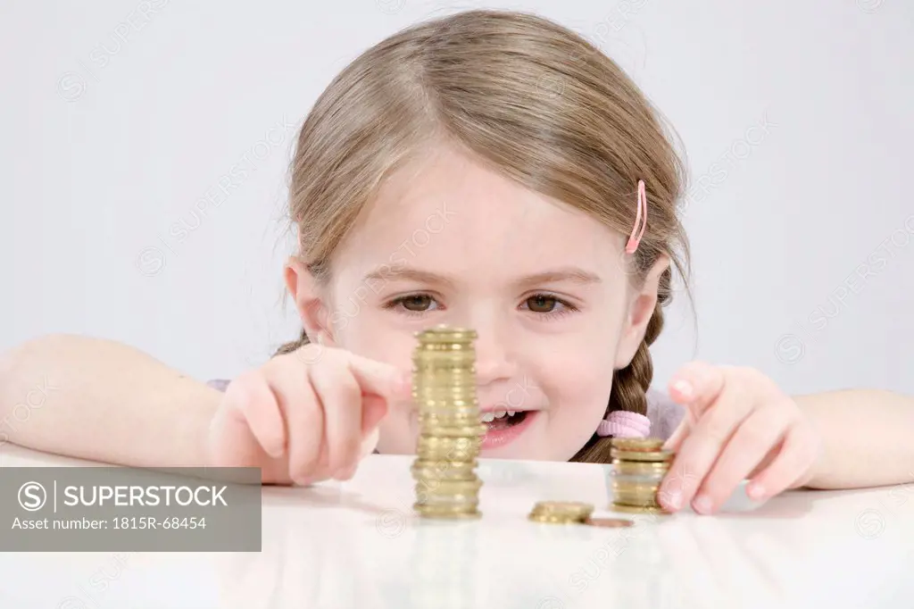 Girl 4_5 counting stack of coins