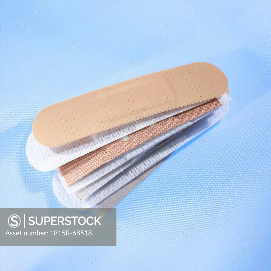 Stack of band_aids on blue background