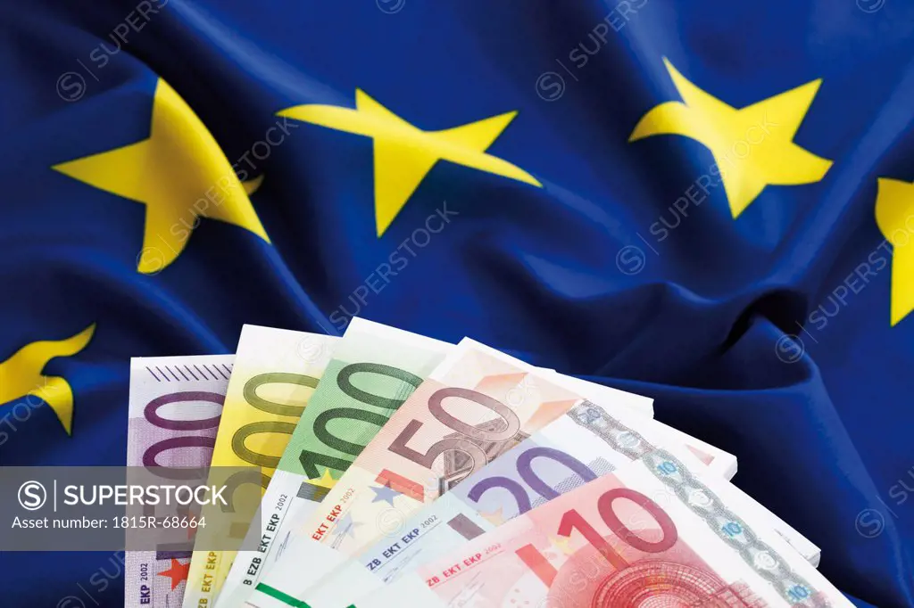 Euro notes fanned out on european union flag
