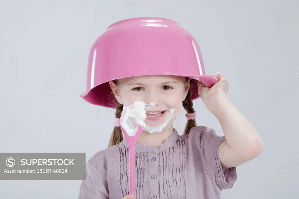 Girl 4_5 with messy face wearing bowl hat and spoon