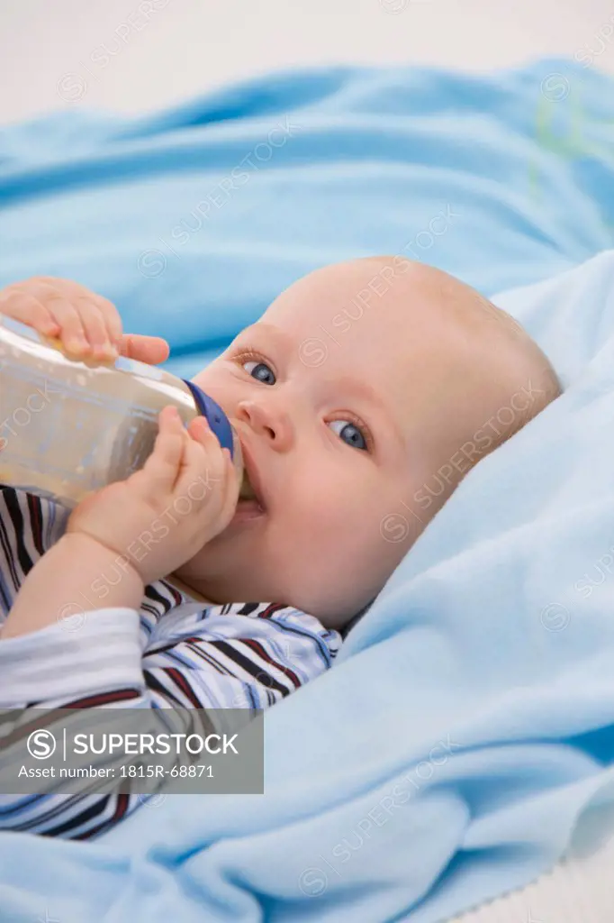 Baby boy 6_11 months holding baby bottle, portrait