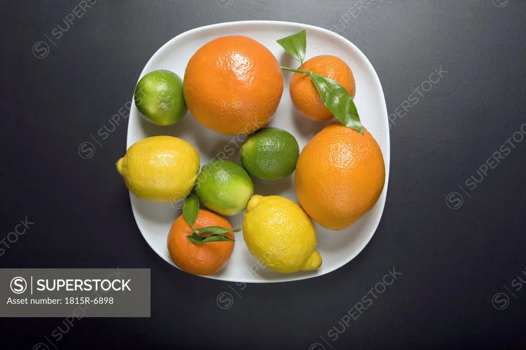 Citrus fruits on plate, elevated view