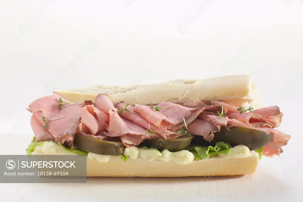 Baguette filled with slices of roast beef.