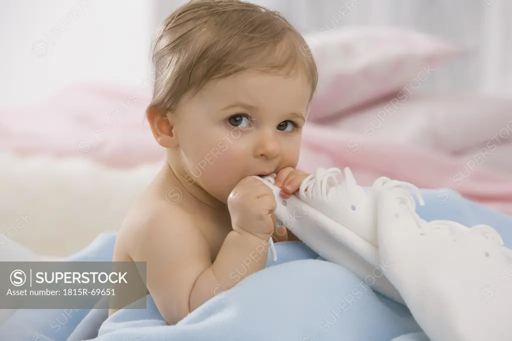 Baby girl 6_11 months biting blanket, portrait