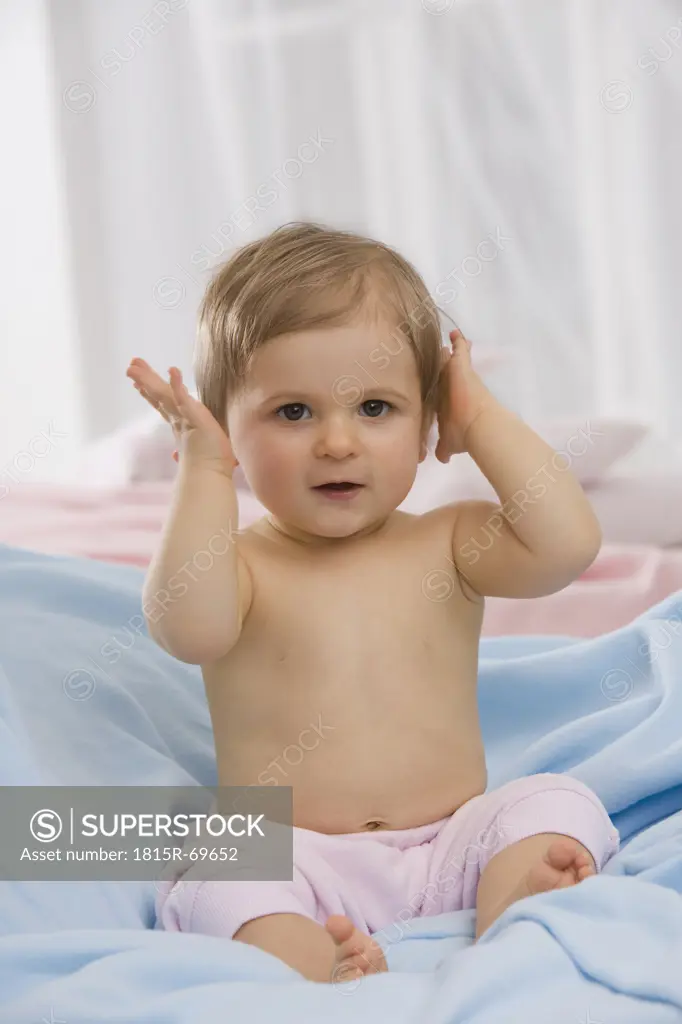 Baby boy 6_11 months hands over ears, portrait