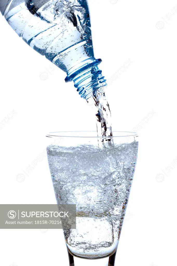 Mineral water being poured into glass, close_up