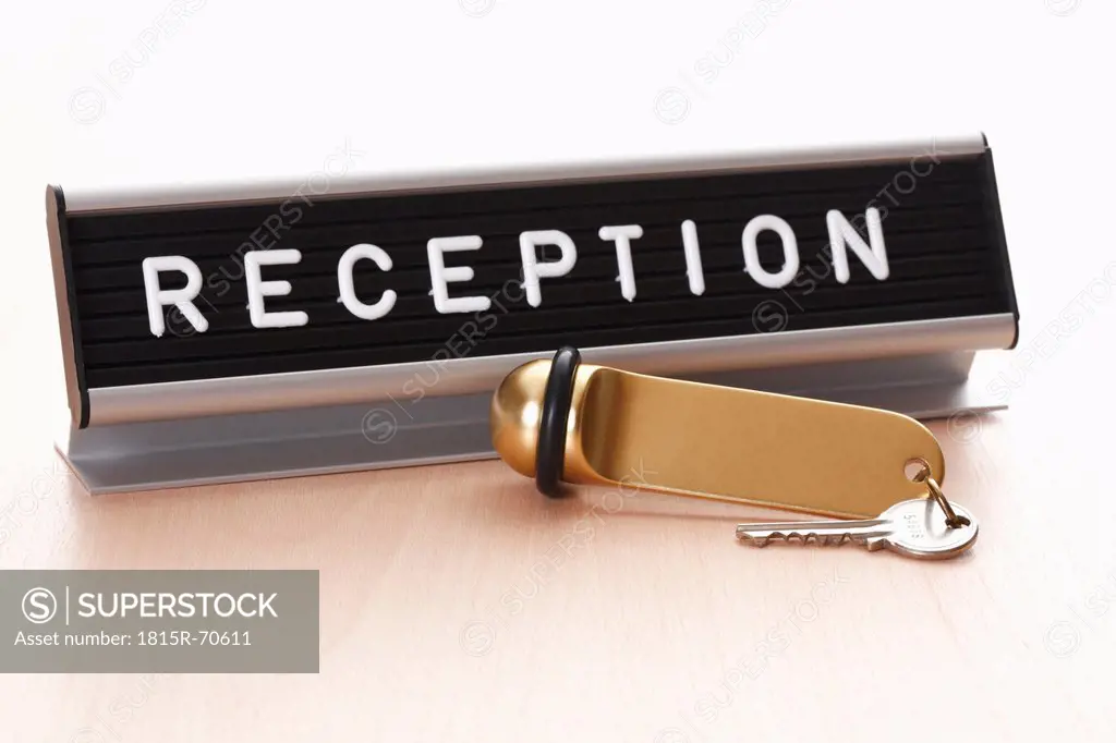 Reception sign with hotel key on desk