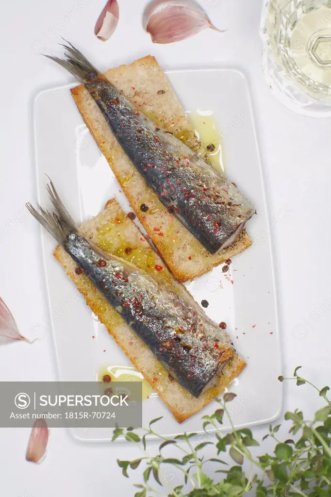 Garnished sardine on ciabatta bread.