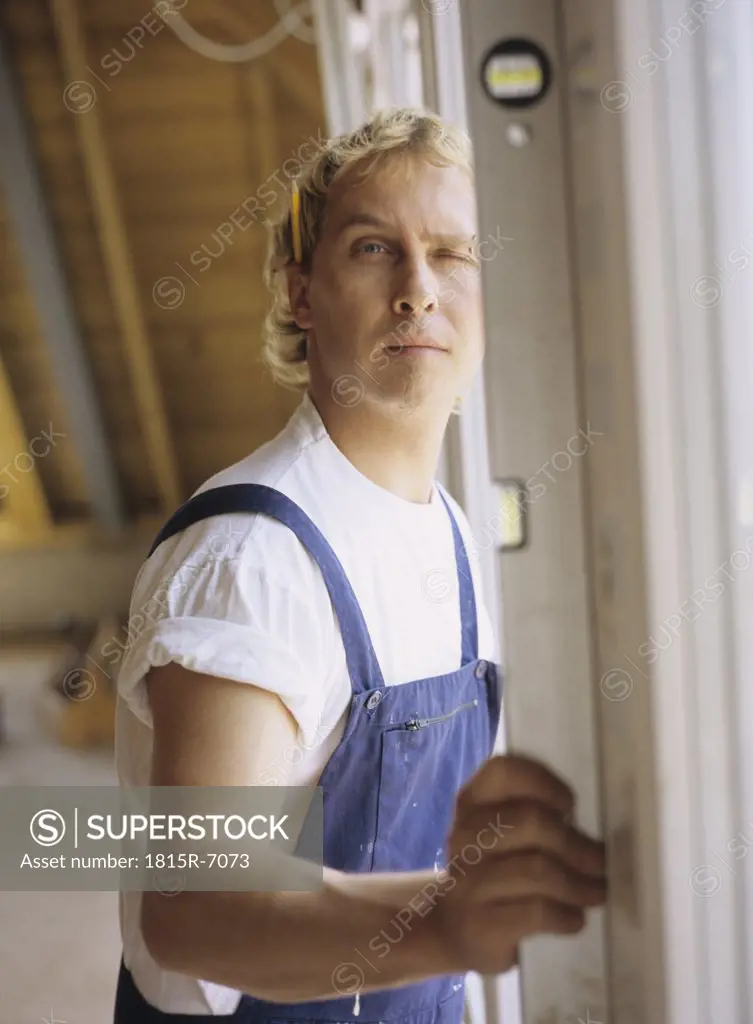 Young craftsman standing, portrait