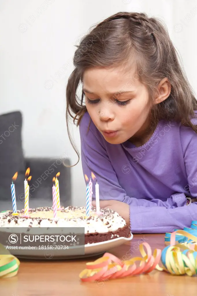 Girl 6_7 blowing out candles on birthday cake