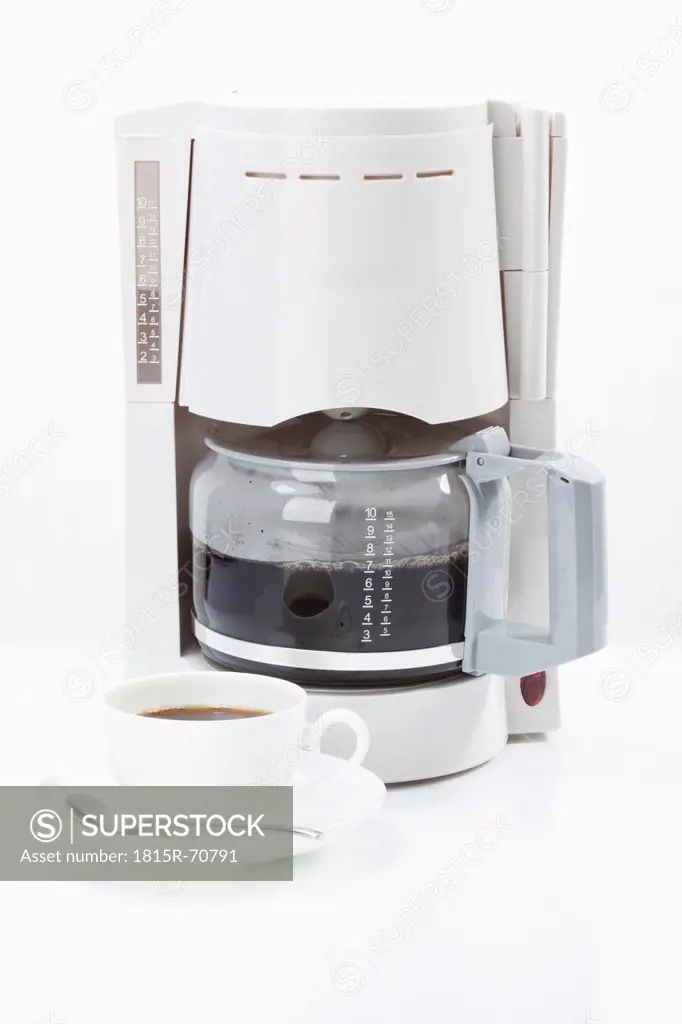 Coffee machine with coffee cup on white background