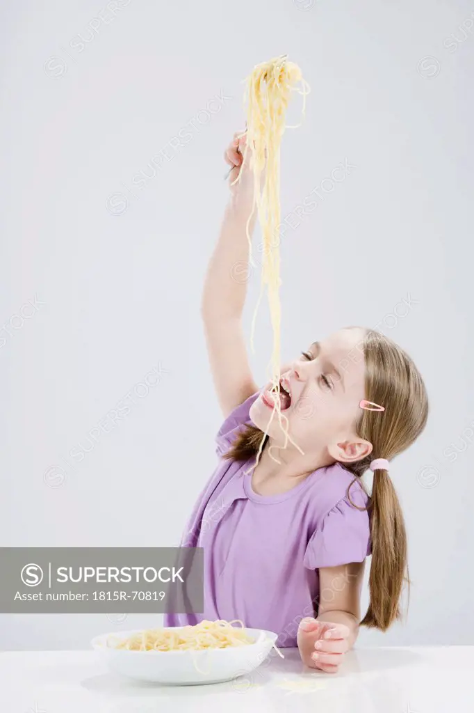 Girl 4_5 eating spagetti, eyes closed