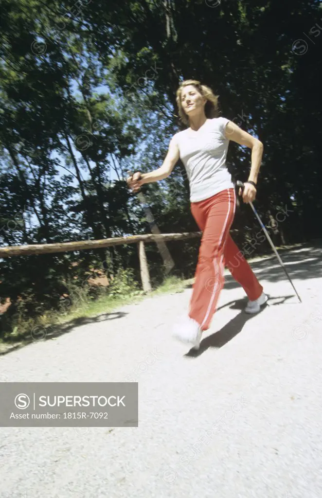 Woman walking with sticks, Nordic walking