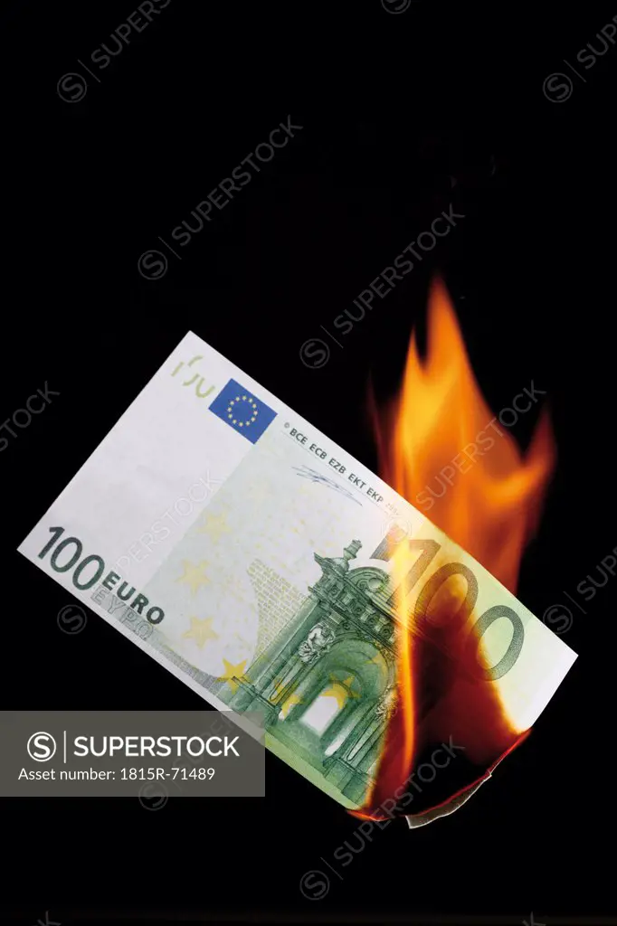 100 euro note burning against black background
