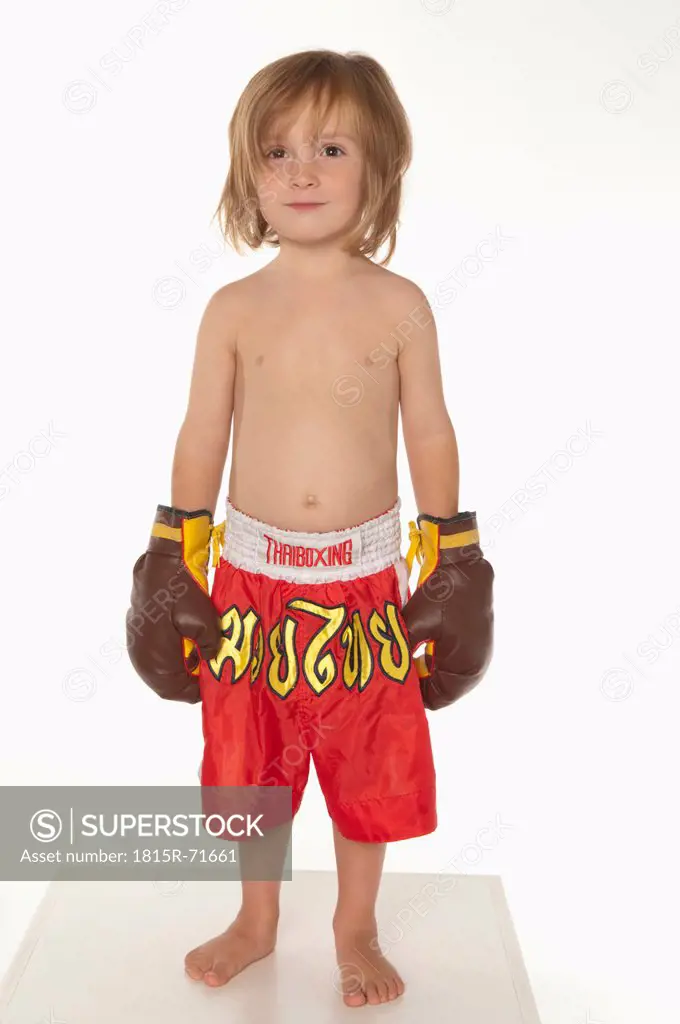 Boy 4_5 wearing boxing glove, smiling