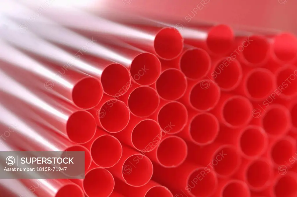 Bunch of red drinking straws, close up.