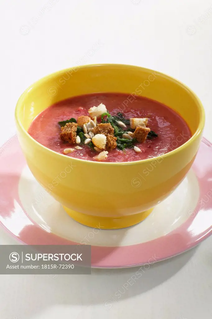 Beetroot and potato soup in bowl garnished with spanish