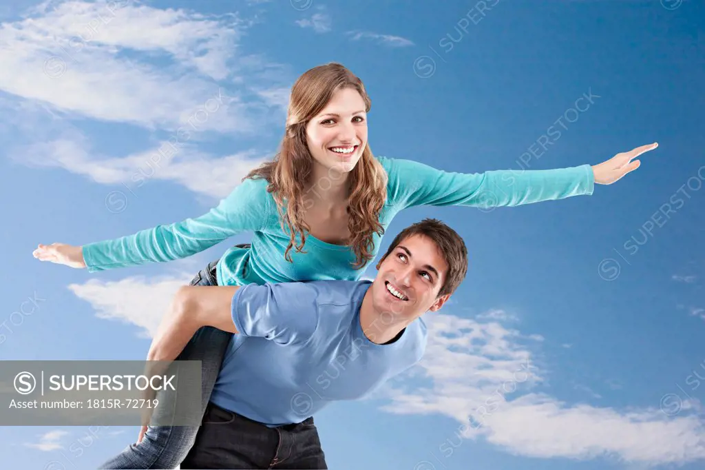 Man carrying woman on back, smiling