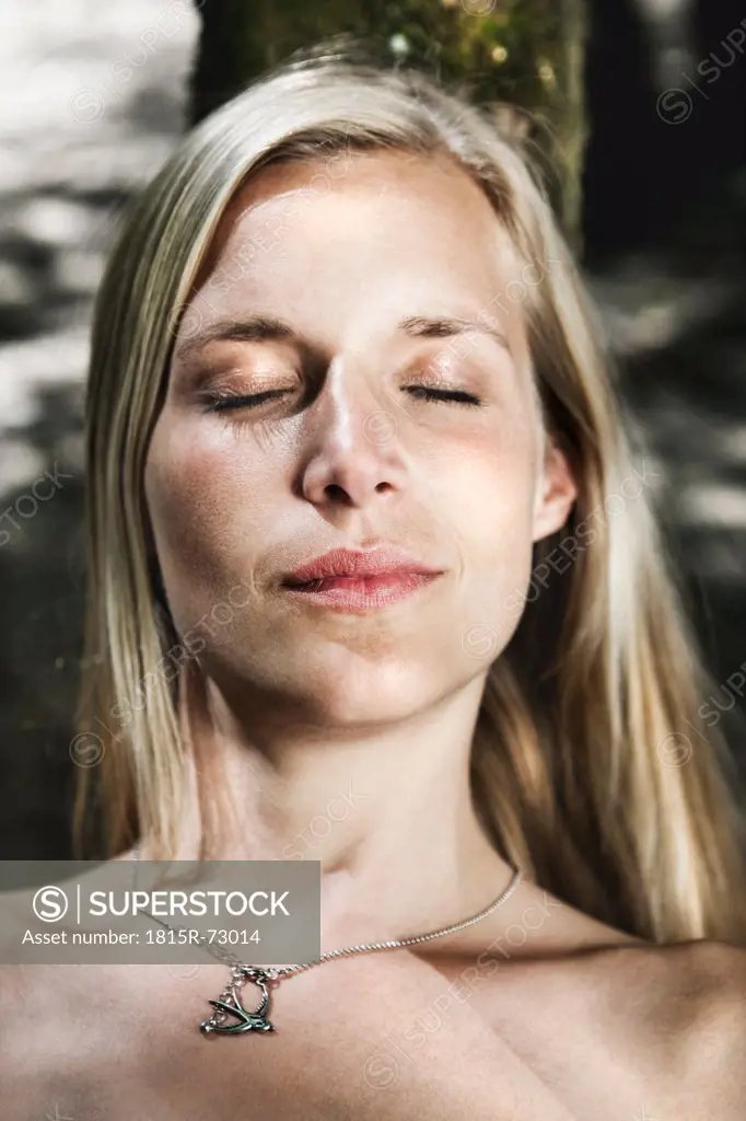 Germany, Cologne, Woman resting with eyes closed