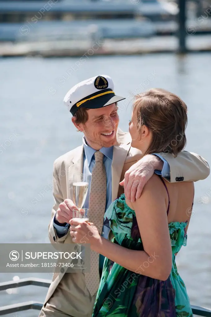 Germany, Hamburg, Couple drinking champagne, smiling