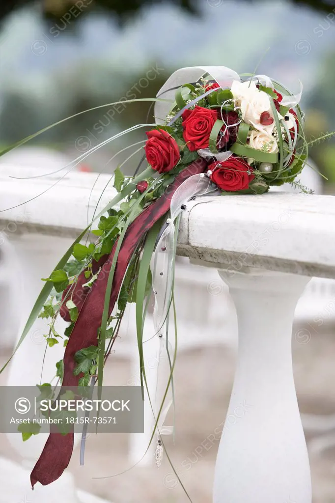 Decorated rose bouquet kept on railing
