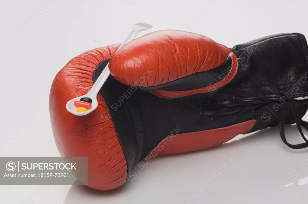 Boxing glove with german national colour pills in plastic spoon